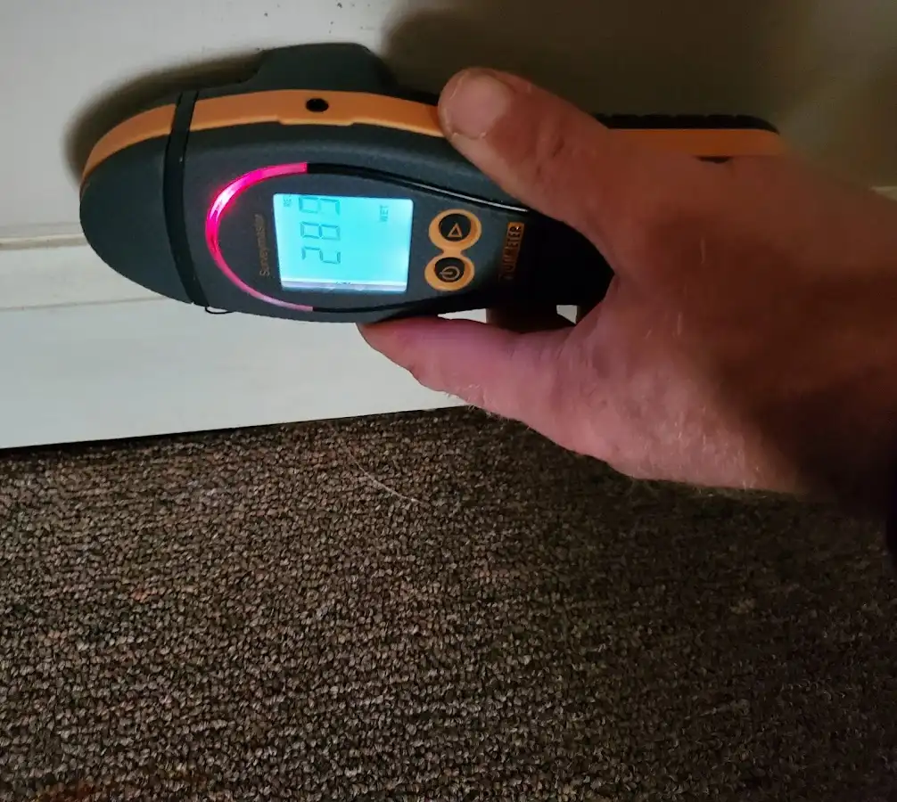 Moisture detection at baseboard during Storm Damage Restoration in Spring Ridge
